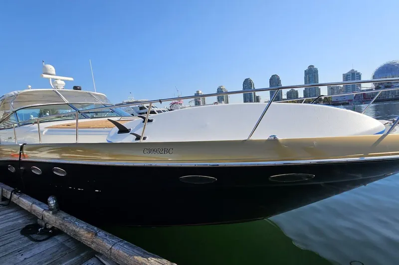  Yacht Photos Pics 1999 Sea Ray 460 Sundancer yacht docked with city skyline in background.
