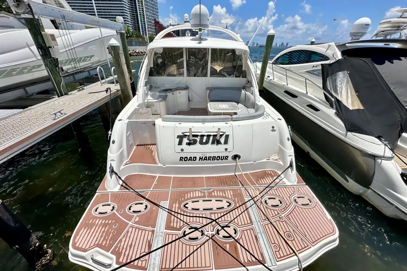 Tsuki Yacht Photos Pics 2005 Sea Ray 48 Sundancer yacht docked at marina, rear view.