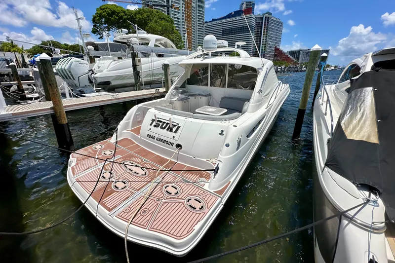 Tsuki Yacht Photos Pics 2005 Sea Ray 48 Sundancer yacht docked at marina, sunny day, clear blue sky.