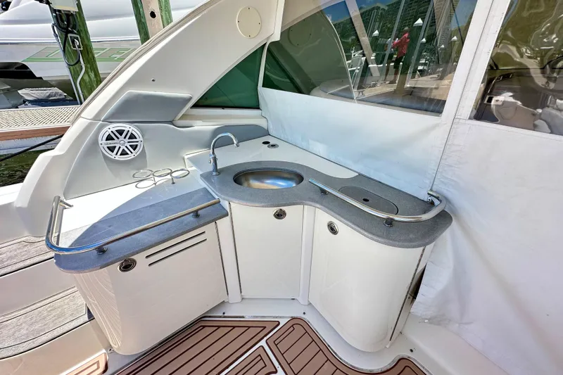 Tsuki Yacht Photos Pics 2005 Sea Ray 48 Sundancer yacht kitchenette with sink and speaker.