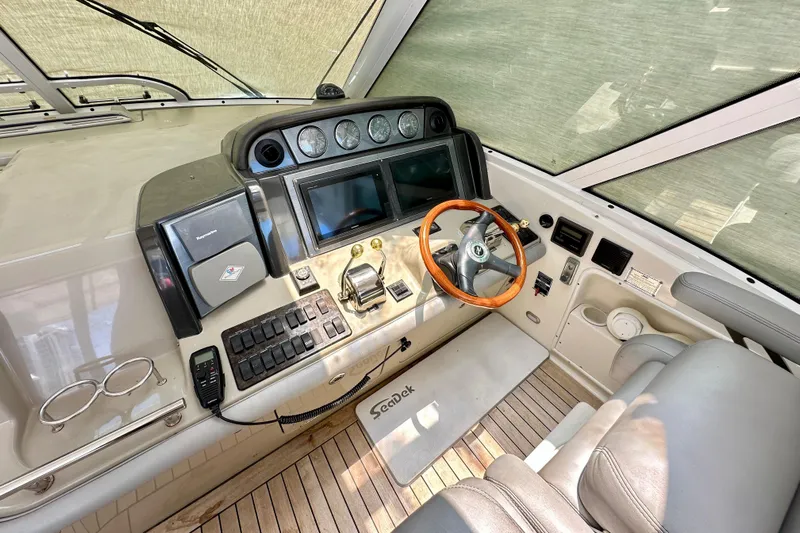Tsuki Yacht Photos Pics 2005 Sea Ray 48 Sundancer helm with steering wheel, controls, and navigation equipment.