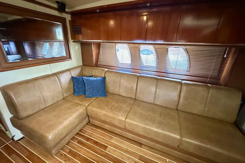 Tsuki Yacht Photos Pics Luxurious interior of 2005 Sea Ray 48 Sundancer yacht with leather seating and wooden accents.