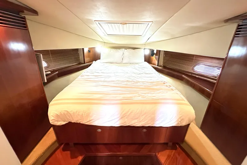 Tsuki Yacht Photos Pics Luxurious cabin interior of 2005 Sea Ray 48 Sundancer yacht with cozy bed.