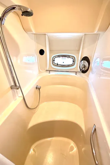 Tsuki Yacht Photos Pics Luxurious shower area in 2005 Sea Ray 48 Sundancer yacht with porthole window.