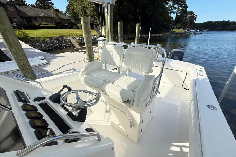  Yacht Photos Pics 2009 Regulator 34SS boat interior with steering wheel and seating at dock.