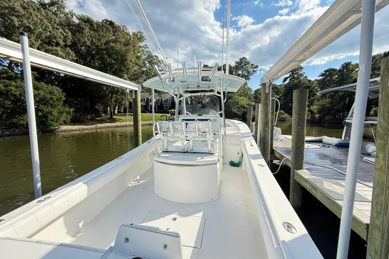  Yacht Photos Pics 2009 Regulator 34SS boat docked, showcasing spacious deck and seating under clear skies.