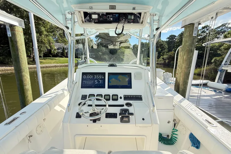  Yacht Photos Pics 2009 Regulator 34SS boat cockpit with navigation screens and steering wheel at dock.