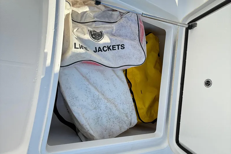  Yacht Photos Pics Storage compartment with life jackets on a 2009 Regulator 34SS boat.