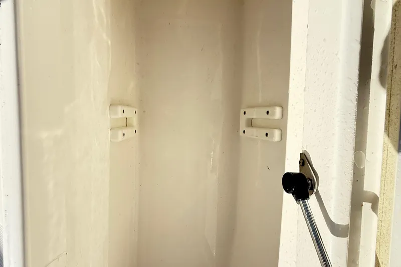  Yacht Photos Pics Open storage compartment on a 2009 Regulator 34SS boat, showing interior hinges and latch.