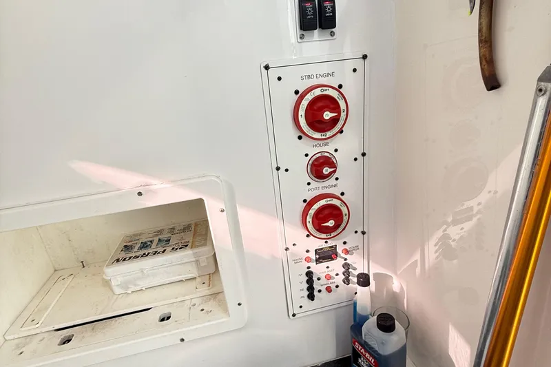  Yacht Photos Pics Control panel of a 2009 Regulator 34SS boat with engine switches and storage compartment.