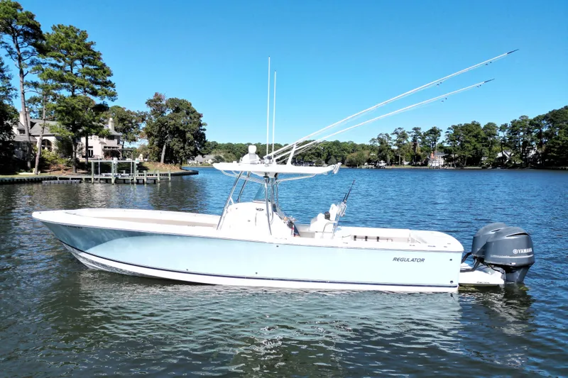  Yacht Photos Pics 2009 Regulator 34SS boat on a serene lake with Yamaha engines.