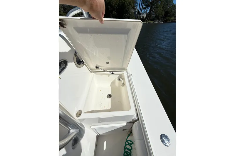  Yacht Photos Pics Open storage compartment on 2009 Regulator 34SS boat, near water.