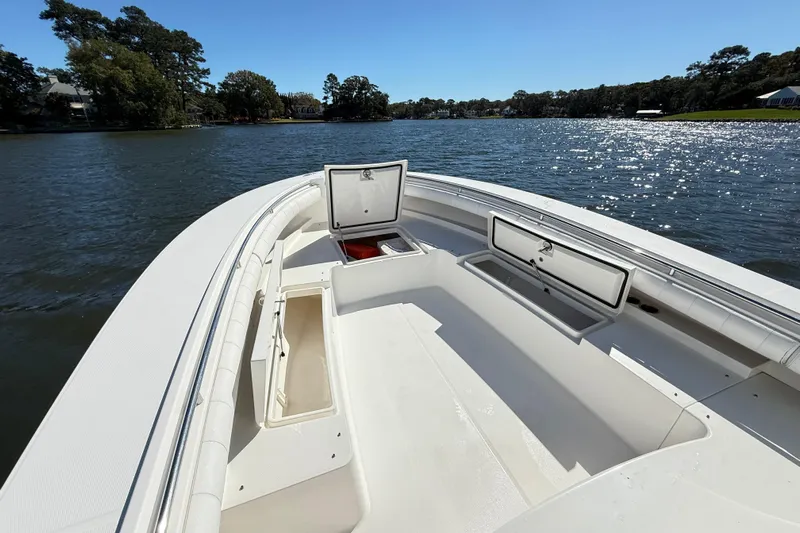  Yacht Photos Pics 2009 Regulator 34SS boat on a sunny lake, open storage compartments visible.