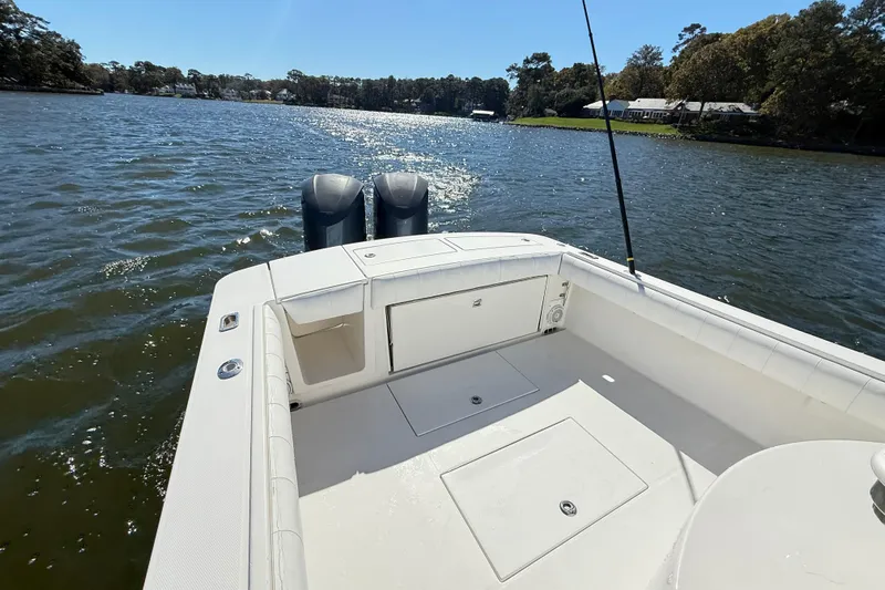 Yacht Photos Pics 2009 Regulator 34SS boat on a sunny lake, featuring dual outboard motors.