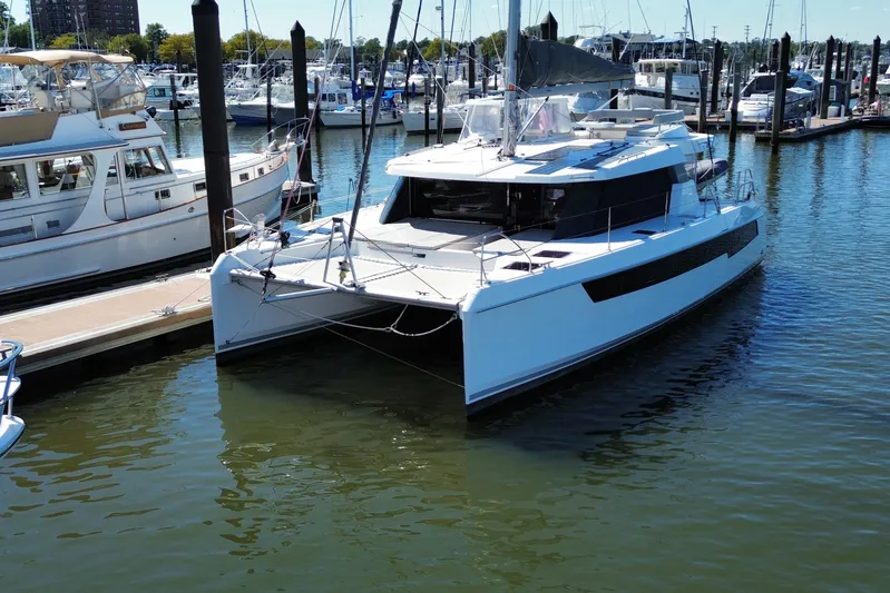 Jolly Time Yacht Photos Pics 2021 Leopard 42 catamaran docked at marina, surrounded by other boats.