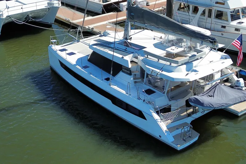 Jolly Time Yacht Photos Pics 2021 Leopard 42 catamaran docked at marina, featuring sleek design and spacious deck.