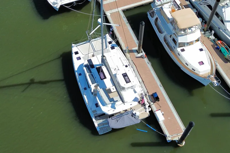 Jolly Time Yacht Photos Pics Aerial view of a 2021 Leopard 42 catamaran docked at a marina.