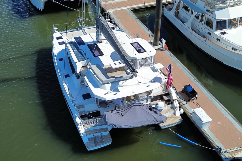 Jolly Time Yacht Photos Pics Aerial view of a 2021 Leopard 42 catamaran docked at a marina.
