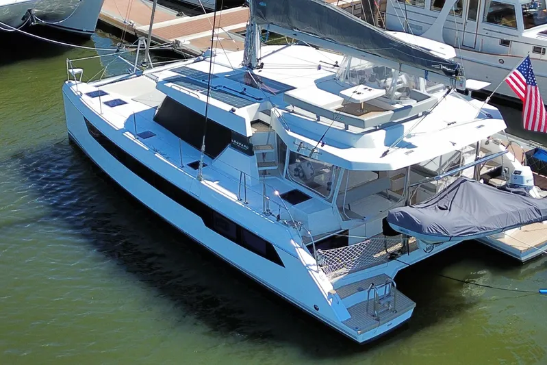 Jolly Time Yacht Photos Pics 2021 Leopard 42 catamaran docked, featuring sleek design and spacious deck layout.