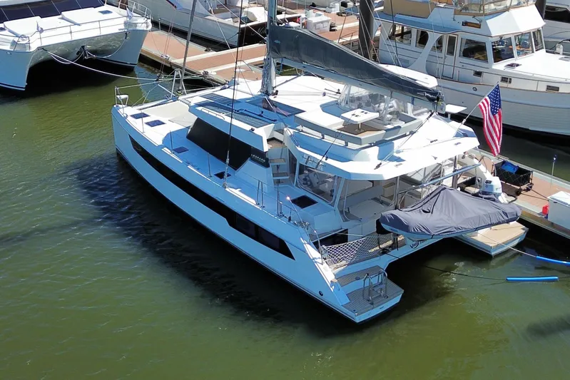 Jolly Time Yacht Photos Pics 2021 Leopard 42 catamaran docked at marina, featuring sleek design and spacious deck.