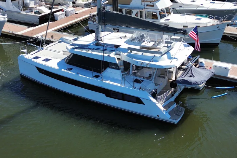 Jolly Time Yacht Photos Pics 2021 Leopard 42 catamaran docked at marina, featuring sleek design and American flag.