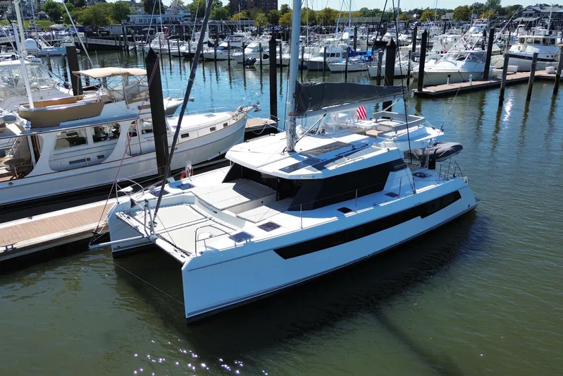 Jolly Time Yacht Photos Pics 2021 Leopard 42 catamaran docked at a marina, surrounded by other boats.
