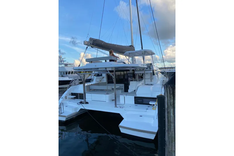 Jolly Time Yacht Photos Pics 2021 Leopard 42 catamaran docked at marina under blue sky.