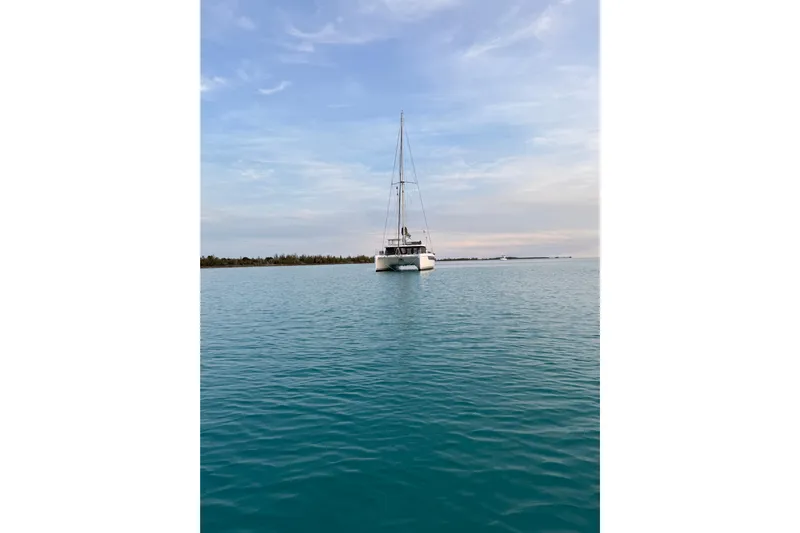Jolly Time Yacht Photos Pics Sailing catamaran Leopard 42, 2021 model, on calm blue waters under a clear sky.
