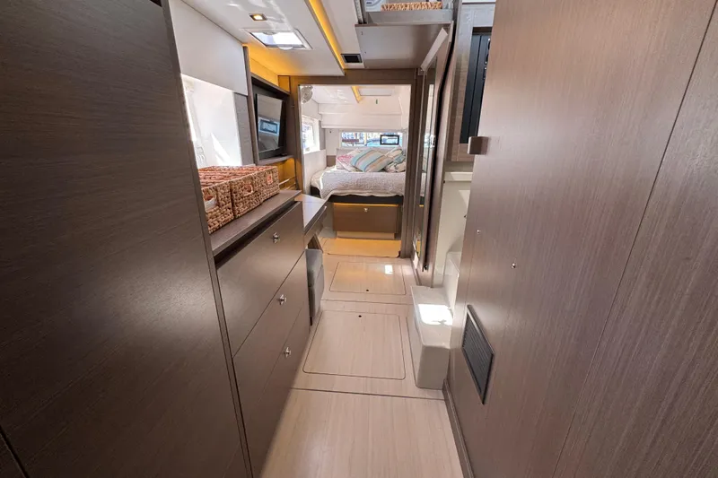 Jolly Time Yacht Photos Pics Luxurious interior of 2021 Leopard 42 yacht with modern wood finishes and cozy bedroom.