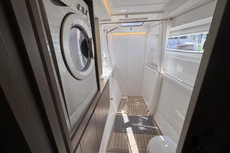 Jolly Time Yacht Photos Pics Laundry area in a 2021 Leopard 42 yacht, featuring a washing machine and modern design.