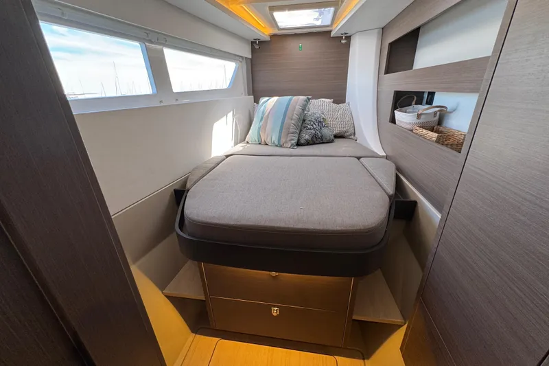 Jolly Time Yacht Photos Pics Luxurious cabin interior of 2021 Leopard 42 yacht with cozy bed and modern decor.