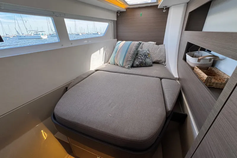 Jolly Time Yacht Photos Pics Cozy cabin interior of 2021 Leopard 42 yacht with bed and decorative pillows.