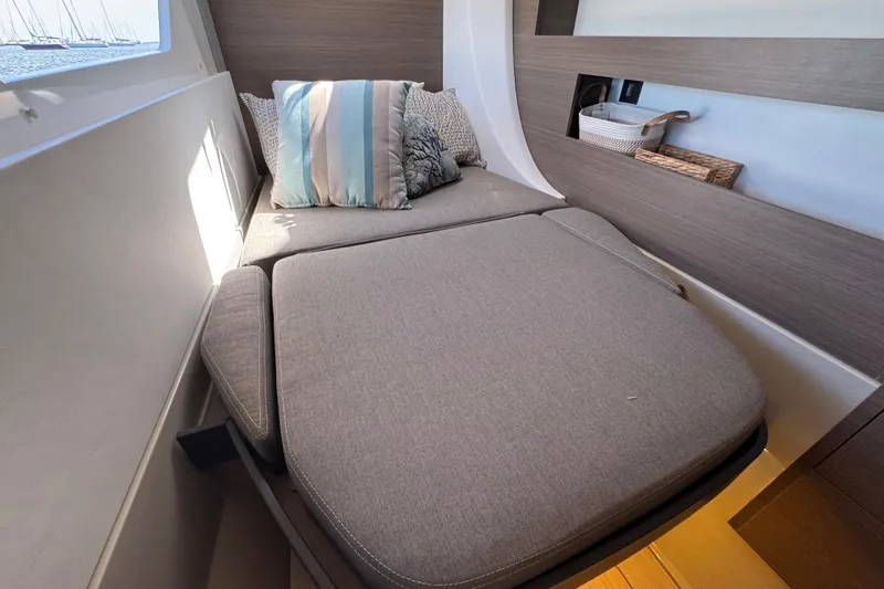 Jolly Time Yacht Photos Pics Cozy cabin interior of 2021 Leopard 42 yacht with cushioned bed and decorative pillows.