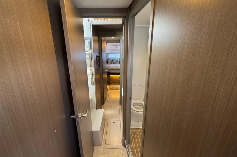 Jolly Time Yacht Photos Pics Interior of 2021 Leopard 42 yacht showing hallway, bathroom, and bedroom.