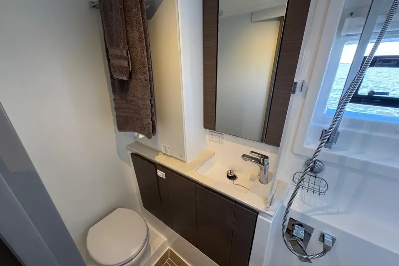 Jolly Time Yacht Photos Pics Modern bathroom in 2021 Leopard 42 yacht with sleek fixtures and ocean view.