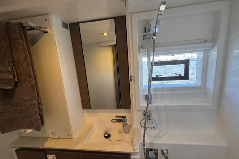 Jolly Time Yacht Photos Pics Modern bathroom in 2021 Leopard 42 yacht with sink, mirror, and window view.