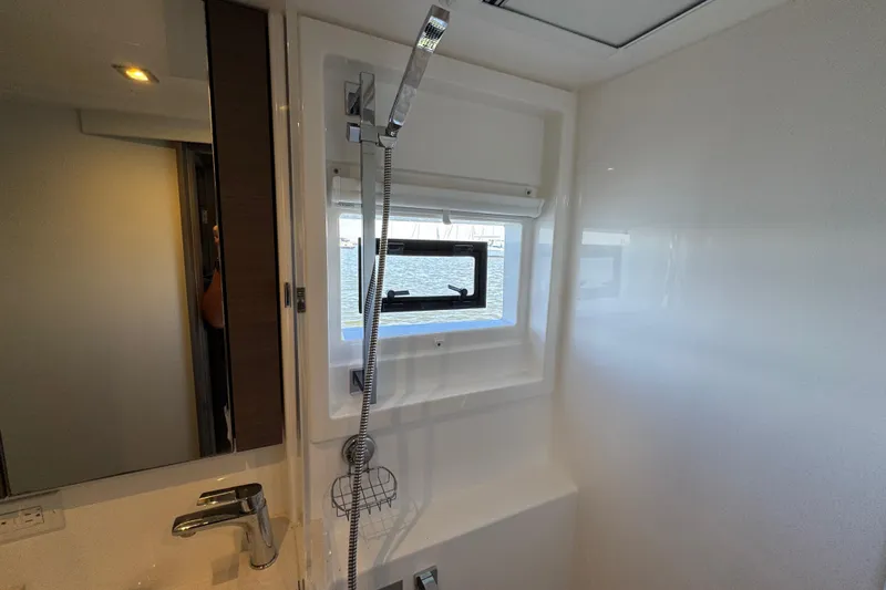 Jolly Time Yacht Photos Pics Modern bathroom interior on 2021 Leopard 42 yacht with window and shower.