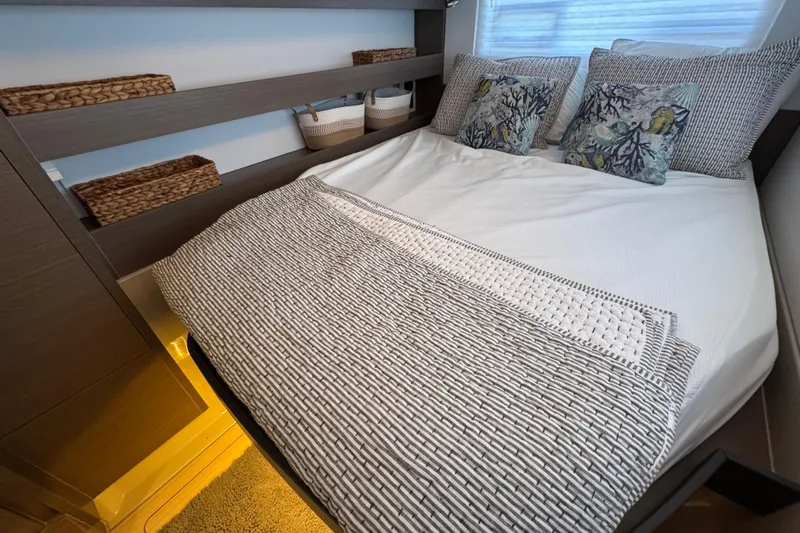 Jolly Time Yacht Photos Pics Cozy bedroom in 2021 Leopard 42 yacht with stylish bedding and decorative pillows.