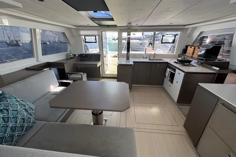 Jolly Time Yacht Photos Pics Modern interior of 2021 Leopard 42 catamaran with spacious kitchen and seating area.