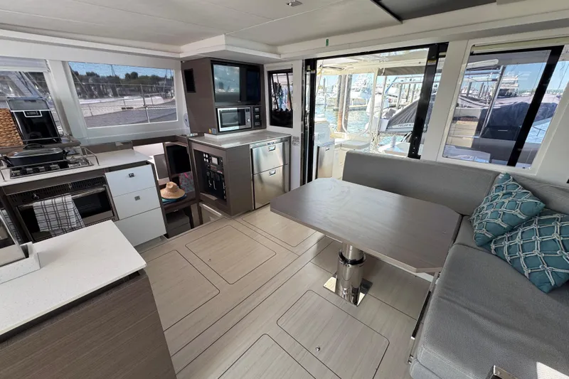 Jolly Time Yacht Photos Pics Modern interior of 2021 Leopard 42 yacht with kitchen and seating area.