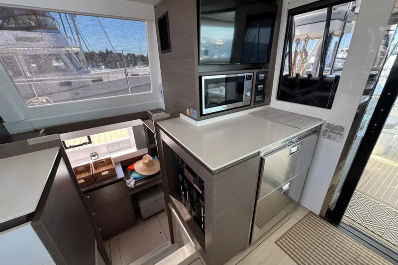 Jolly Time Yacht Photos Pics Modern kitchen interior on 2021 Leopard 42 yacht with appliances and outdoor view.