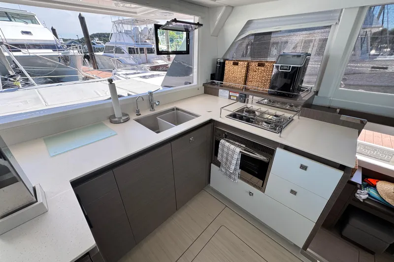 Jolly Time Yacht Photos Pics Modern kitchen interior on a 2021 Leopard 42 yacht, featuring sleek countertops and appliances.
