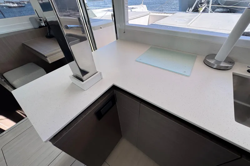 Jolly Time Yacht Photos Pics Modern kitchen interior on 2021 Leopard 42 yacht with sleek countertops and ocean view.