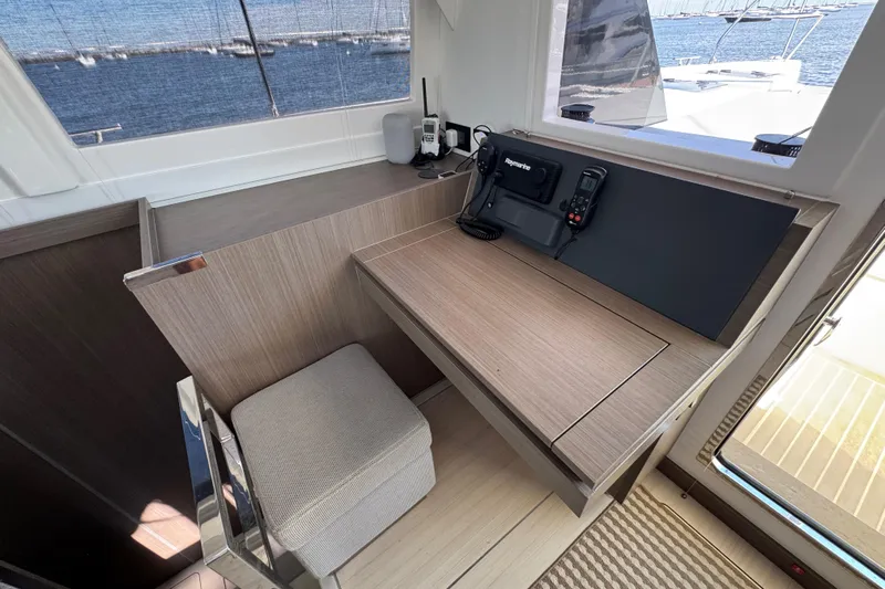 Jolly Time Yacht Photos Pics Navigation station on 2021 Leopard 42 catamaran with communication equipment and ocean view.