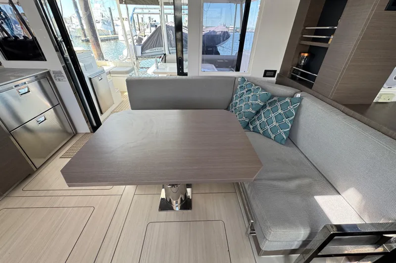 Jolly Time Yacht Photos Pics Modern interior of 2021 Leopard 42 yacht with dining area and marina view.