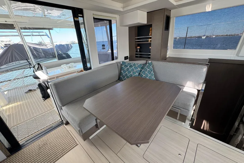 Jolly Time Yacht Photos Pics Modern interior of 2021 Leopard 42 yacht with dining area and ocean view.