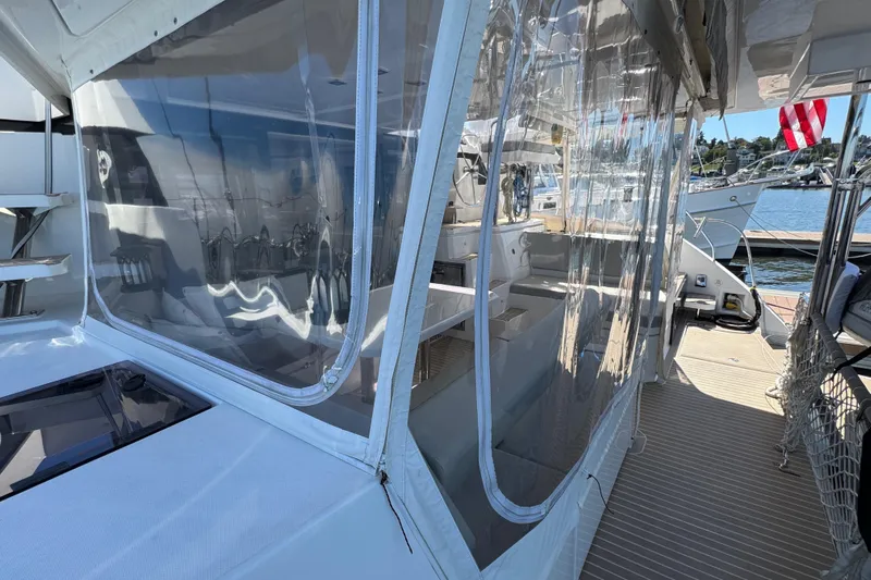 Jolly Time Yacht Photos Pics 2021 Leopard 42 yacht with clear enclosures docked at marina.