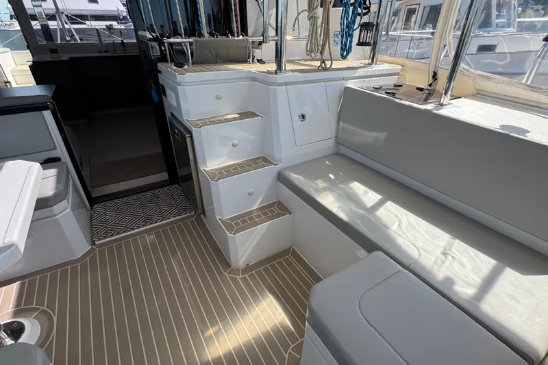Jolly Time Yacht Photos Pics Interior of a 2021 Leopard 42 yacht featuring seating and steps.