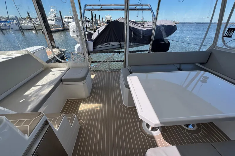 Jolly Time Yacht Photos Pics Leopard 42 yacht interior with seating and table, docked at marina, 2021 model.