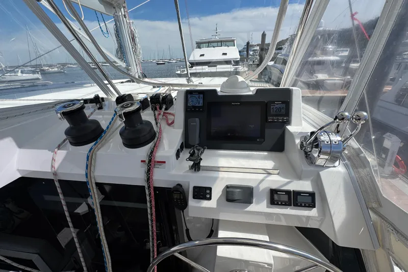 Jolly Time Yacht Photos Pics Helm of 2021 Leopard 42 catamaran with navigation controls and winches, docked in marina.